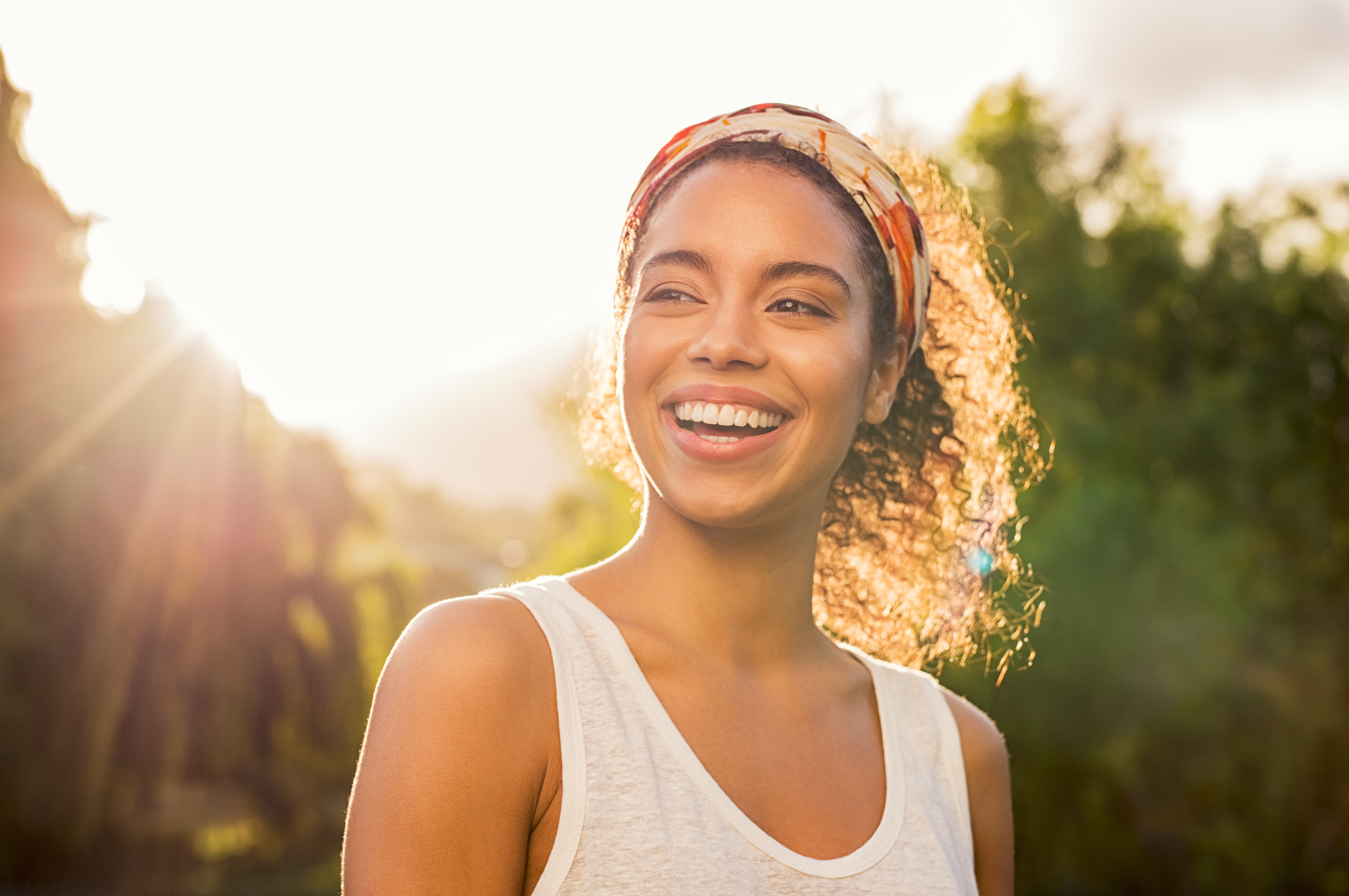 Woman smiling outdoors, representing hope and recovery